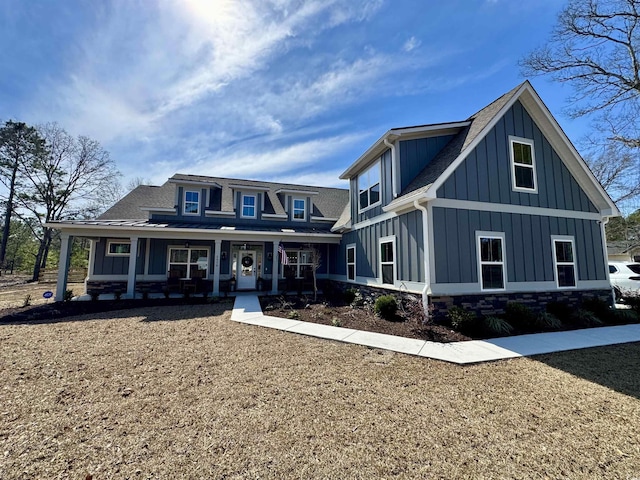 view of front of home featuring a porch, board and batten siding, and roof with shingles