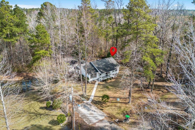 birds eye view of property with a wooded view