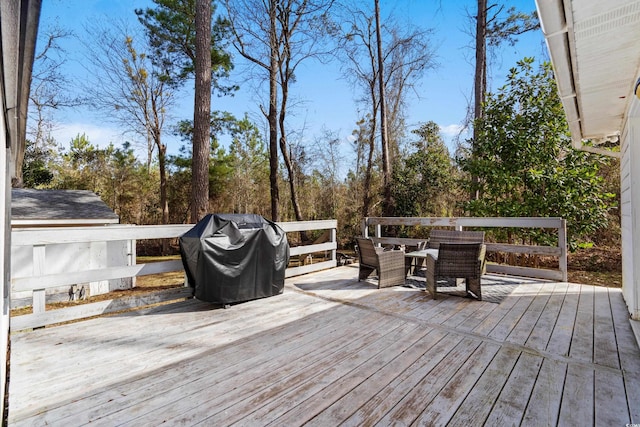 deck with outdoor dining area and grilling area