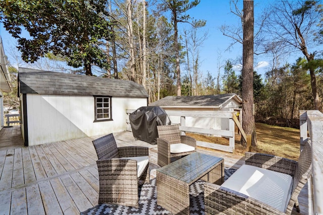 wooden terrace with a storage unit, grilling area, an outdoor structure, and an outdoor living space