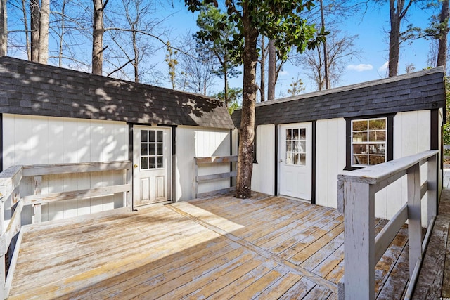 wooden terrace with an outbuilding