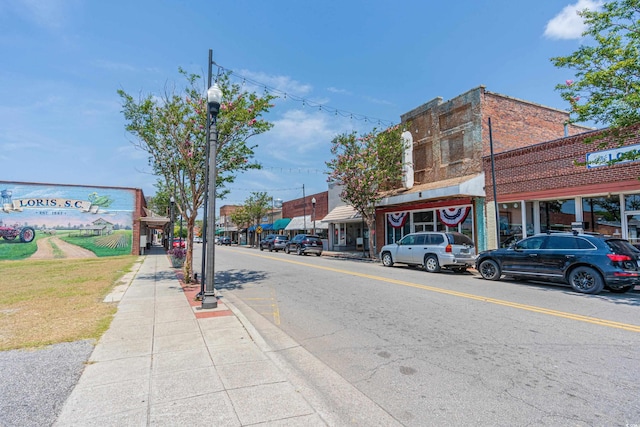 view of street featuring curbs, street lighting, and sidewalks