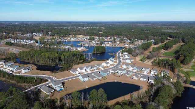 bird's eye view featuring a water view, a wooded view, and a residential view