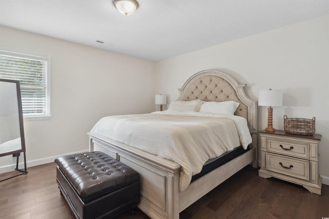 bedroom featuring visible vents, dark wood finished floors, and baseboards