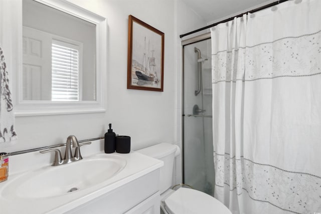 bathroom featuring toilet, vanity, and a shower with shower curtain