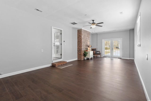 unfurnished living room with dark wood-style floors, french doors, and visible vents