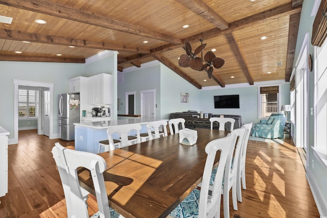 dining room featuring light wood-style floors, wooden ceiling, and beamed ceiling