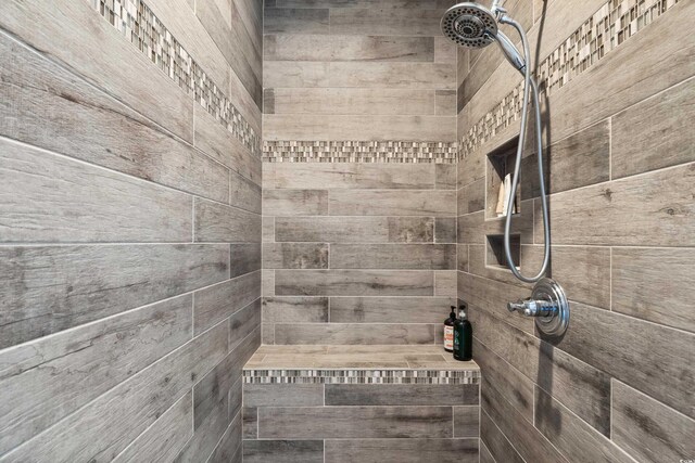 interior details featuring a tile shower