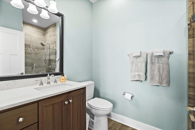 full bath featuring toilet, vanity, baseboards, a shower stall, and an inviting chandelier
