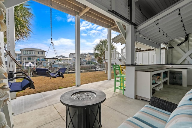 view of patio / terrace featuring a fire pit and a bar