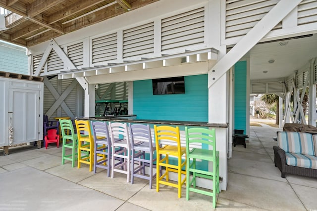 view of patio / terrace featuring an outdoor bar