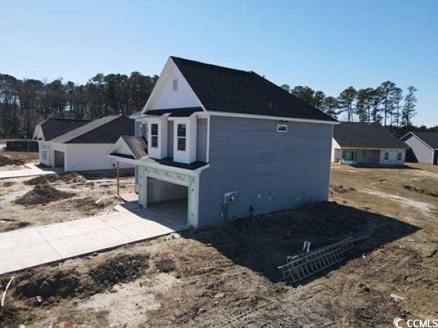 view of home's exterior with a garage and concrete driveway