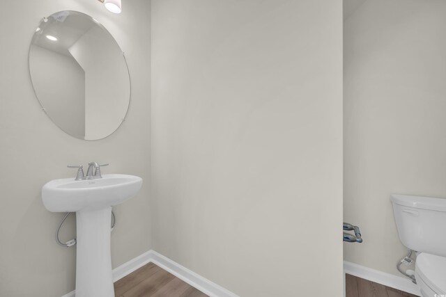 1064 Jase Dr, Longs, SC 29568 - bathroom featuring toilet, wood finished floors, baseboards, and a sink