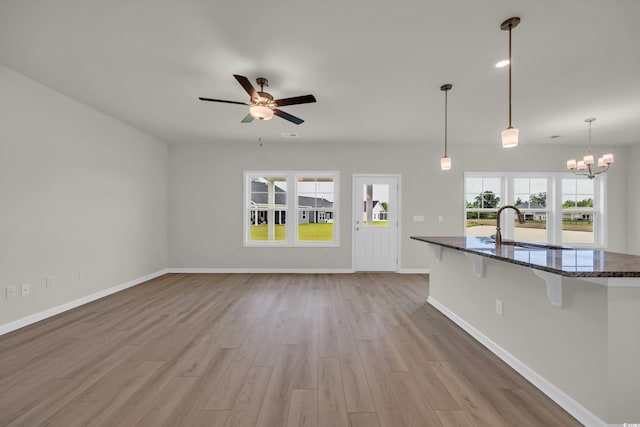 1064 Jase Dr, Longs, SC 29568 - unfurnished living room with a sink, light wood finished floors, a ceiling fan, and baseboards