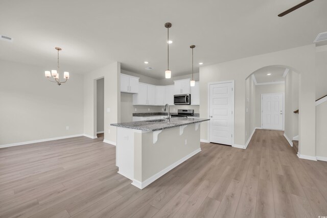 1064 Jase Dr, Longs, SC 29568 - kitchen with stainless steel appliances, a sink, arched walkways, light wood-type flooring, and recessed lighting
