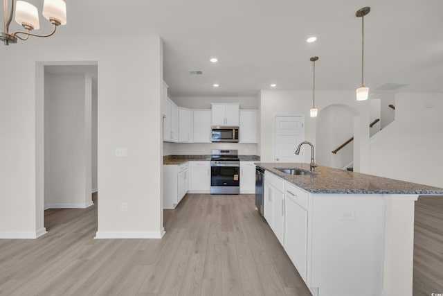 1064 Jase Dr, Longs, SC 29568 - kitchen with stainless steel appliances, a sink, light wood-style floors, dark stone counters, and recessed lighting