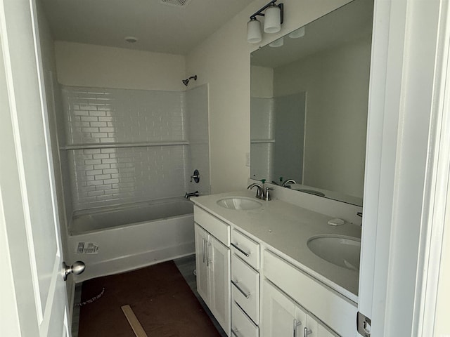 bathroom featuring shower / bathtub combination, double vanity, a sink, and visible vents