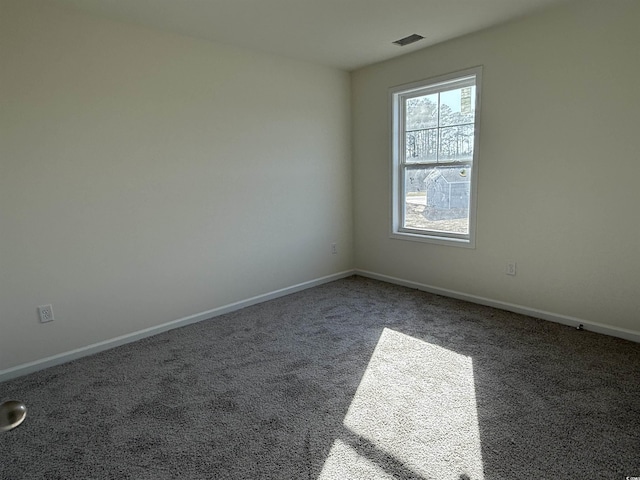 carpeted spare room with baseboards and visible vents