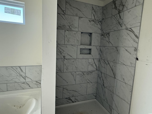 bathroom with a tile shower and a bath