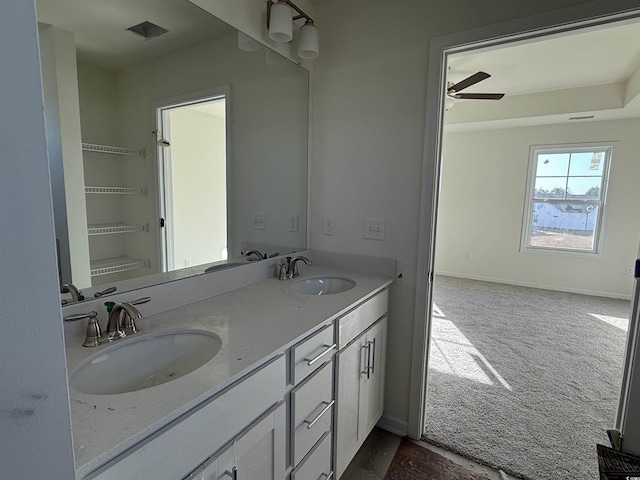 full bathroom with double vanity, baseboards, visible vents, and a sink