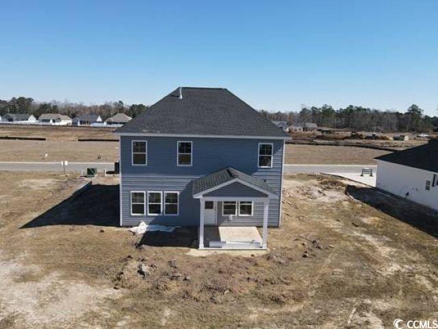 back of property with a patio