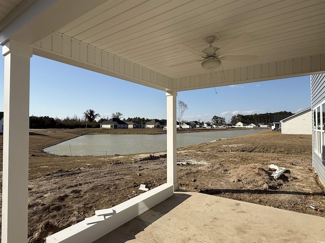 view of patio featuring a water view and ceiling fan