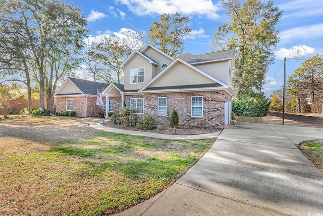 traditional-style home with stucco siding, a front lawn, and brick siding