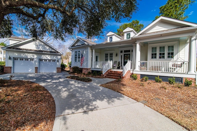 view of front of home featuring a garage, covered porch, and an outdoor structure