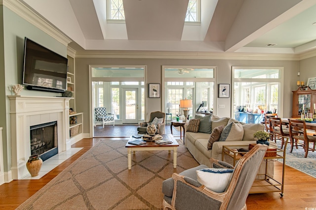 living room featuring a healthy amount of sunlight, a fireplace, and light wood-style flooring