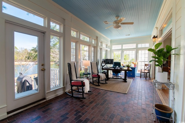 sunroom with a ceiling fan, wood ceiling, and a healthy amount of sunlight