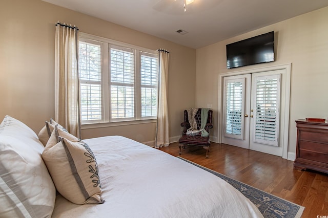 bedroom with french doors, a ceiling fan, wood finished floors, access to outside, and baseboards