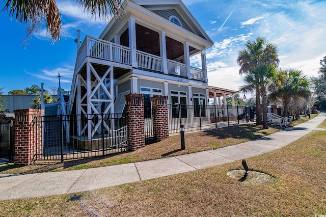 view of front of home with fence and a balcony