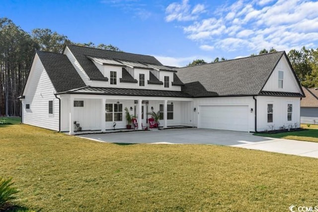 modern farmhouse with a standing seam roof, metal roof, concrete driveway, and a front yard