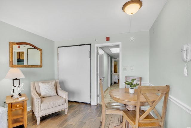 dining area with baseboards and light wood finished floors