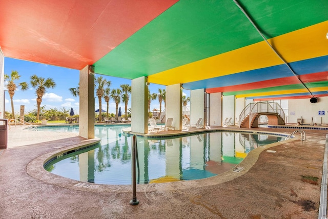 community pool with a patio area