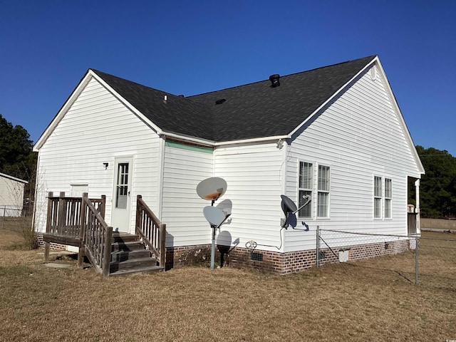 rear view of house with crawl space and a shingled roof