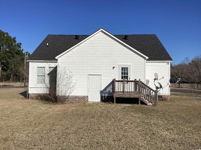 back of house with a lawn, roof with shingles, crawl space, fence, and a deck