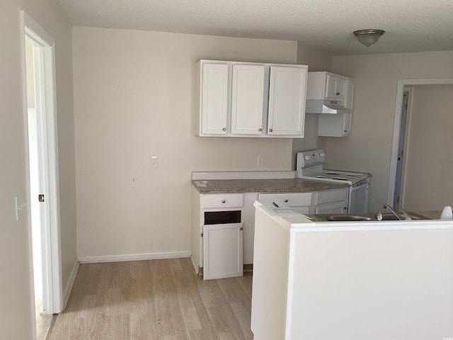 kitchen with light wood-style flooring, under cabinet range hood, baseboards, white cabinets, and white range with electric cooktop