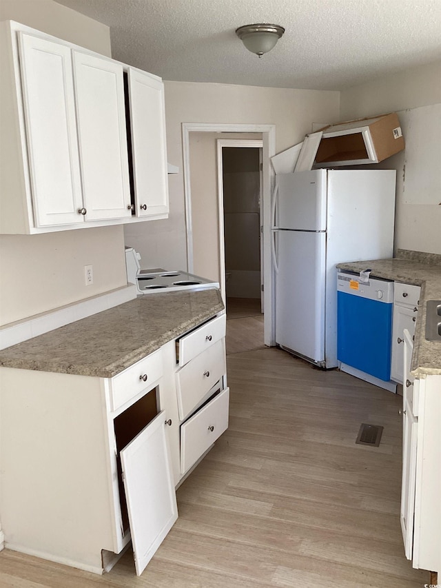 kitchen featuring a textured ceiling, white appliances, light wood-style flooring, and white cabinets