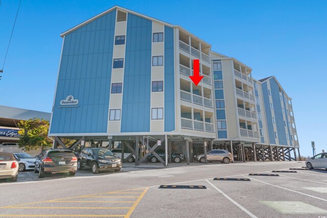 1000 N Waccamaw Dr Unit 205, Murrells Inlet, SC 29576 - view of property featuring covered and uncovered parking