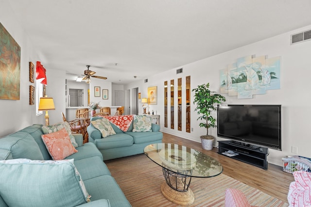 1000 N Waccamaw Dr Unit 205, Murrells Inlet, SC 29576 - living area with a ceiling fan, baseboards, visible vents, and wood finished floors