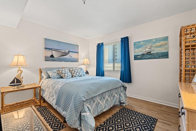 1000 N Waccamaw Dr Unit 205, Murrells Inlet, SC 29576 - bedroom featuring baseboards and wood finished floors
