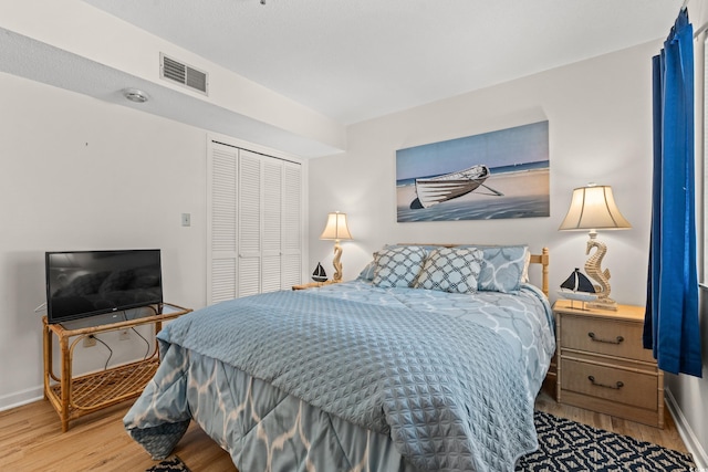 1000 N Waccamaw Dr Unit 205, Murrells Inlet, SC 29576 - bedroom featuring baseboards, a closet, wood finished floors, and visible vents