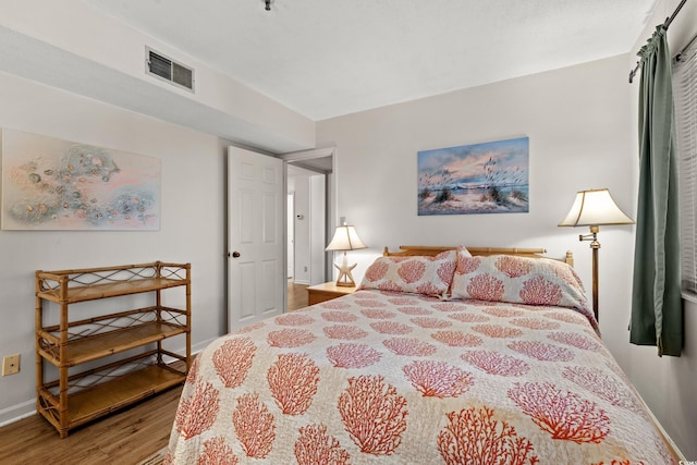 1000 N Waccamaw Dr Unit 205, Murrells Inlet, SC 29576 - bedroom with visible vents, baseboards, and wood finished floors