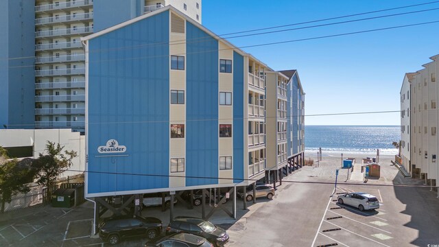 1000 N Waccamaw Dr Unit 205, Murrells Inlet, SC 29576 - view of building exterior featuring a water view and uncovered parking