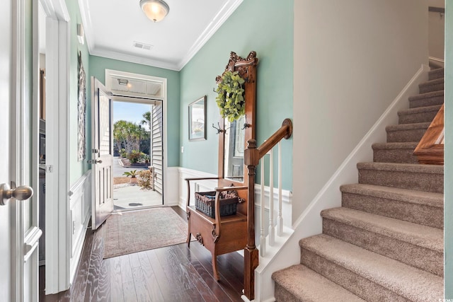 foyer featuring ornamental molding, dark wood-style flooring, visible vents, and stairway