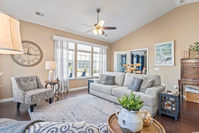 living room featuring dark wood-style floors, ceiling fan, visible vents, and vaulted ceiling