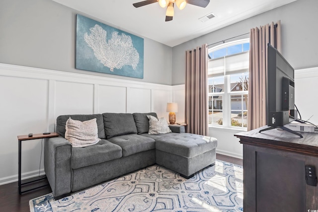 living area with a healthy amount of sunlight, visible vents, ceiling fan, and wood finished floors