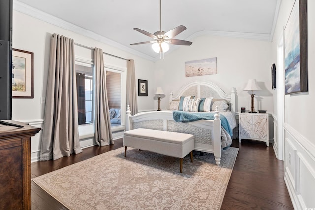 bedroom with lofted ceiling, ornamental molding, dark wood-style flooring, and a ceiling fan