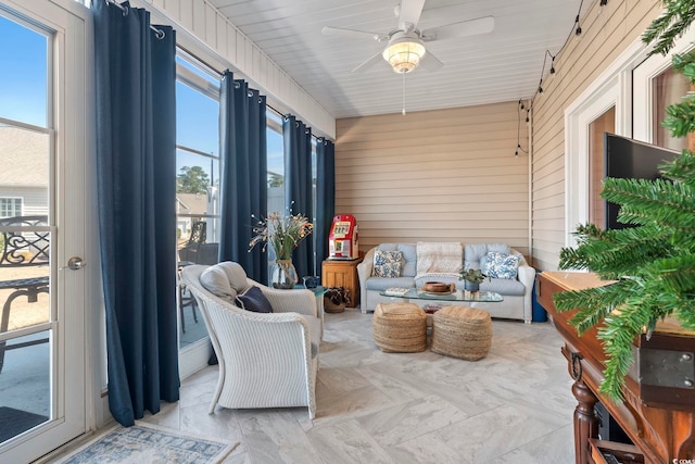 sunroom with a wealth of natural light and a ceiling fan